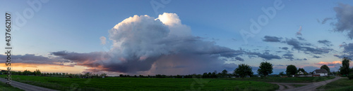 Storm cloud over a field of green wheat