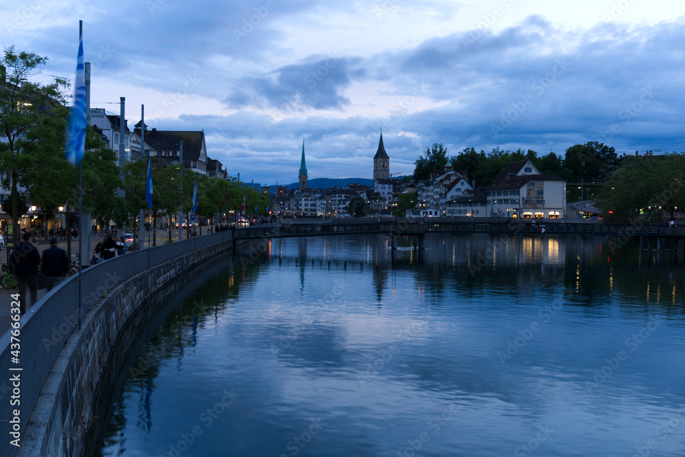 Old town of Zurich with river Limmat and churches St. Peter and Fraumünster (Women's minster) at Saturday night at summertime. Photo taken June 5th, 2021, Zurich, Switzerland.