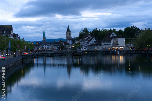 Old town of Zurich with river Limmat and churches St. Peter and Fraumünster (Women's minster) at Saturday night at summertime. Photo taken June 5th, 2021, Zurich, Switzerland.