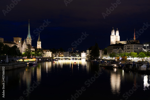 Old town of Zurich with river Limmat and churches St. Peter, Great Minster and Women's Minster at night at summertime. Photo taken June 5th, 2021, Zurich, Switzerland.