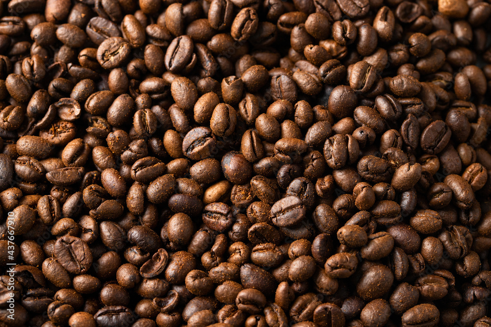 Roasted coffee beans texture background. Close up of detail