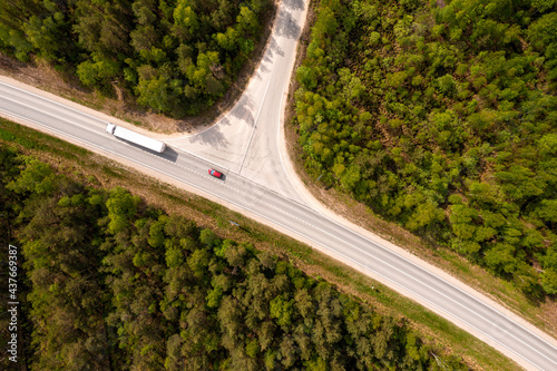 Fotobehang aerial view of road intersection in the forest at summer, drone shot
