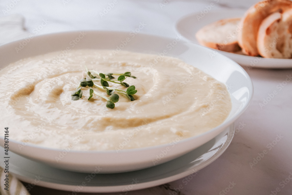 Closeup view of white bowl with mushroom cream soup - healthy food concept. Classic recipe. Selective focus Closeup view of white bowl with mushroom cream soup - healthy food concept. Classic recipe. Selective focus
