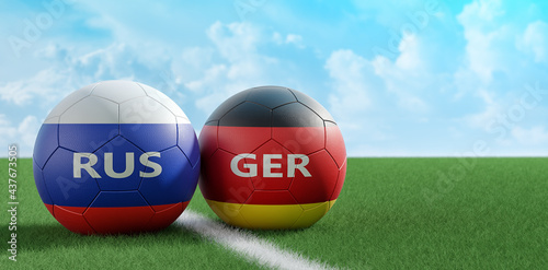Germany vs. Russia Soccer Match - Leather balls in Germany and Russia national colors on a soccer field. Copy space on the right side - 3D Rendering 