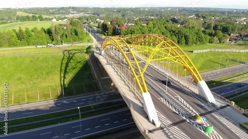 Aerial view of bridge over highway and cars on suburbs