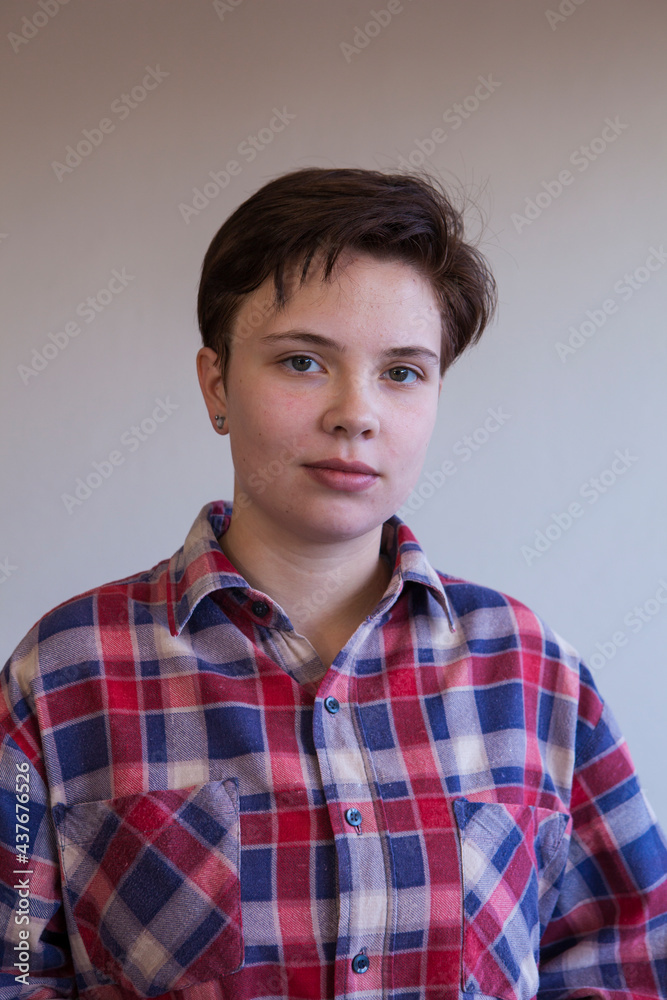 A portrait of a young woman wearing a chequered shirt and no makeup
A portrait of a young woman wearing a chequered shirt and no makeup