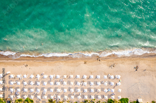 Fototapeta Naklejka Na Ścianę i Meble -  Aerial top view on the beach of Belek, Turkey. Umbrellas, sand and mediterranean sea
