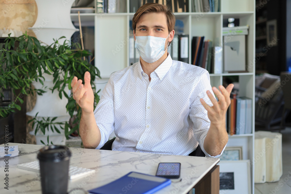 Businessman is working in preventive medical mask in office.