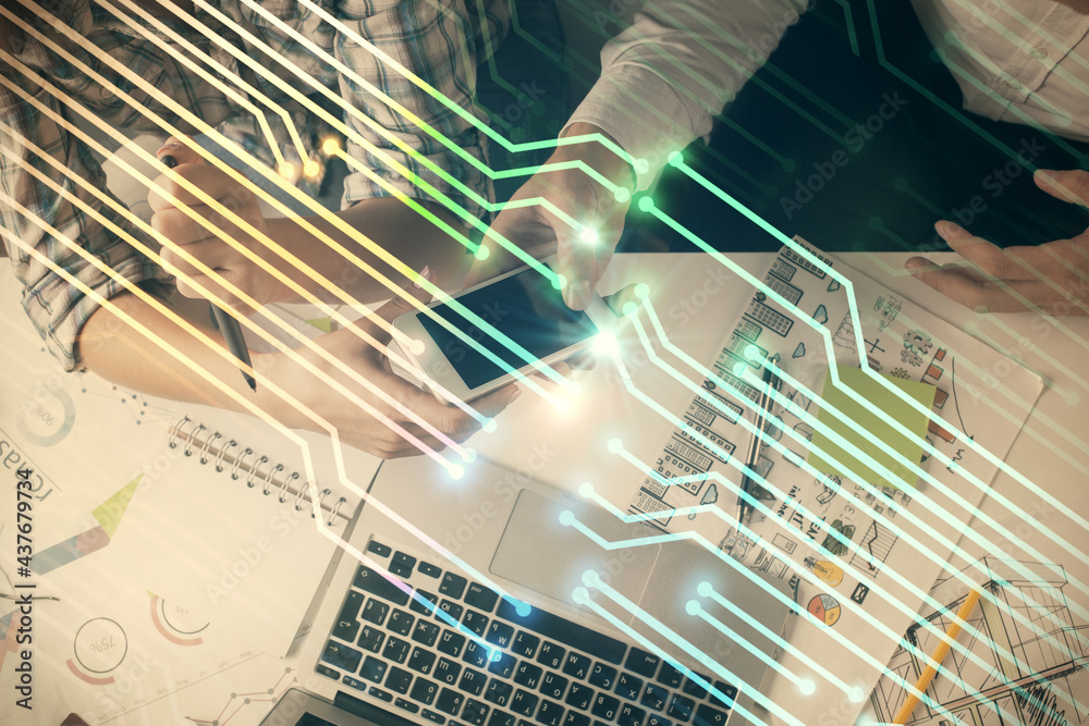 Double exposure of data theme hologram drawing and man and woman working together holding and using a mobile device. Double exposure of data theme hologram drawing and man and woman working together holding and using a mobile device.