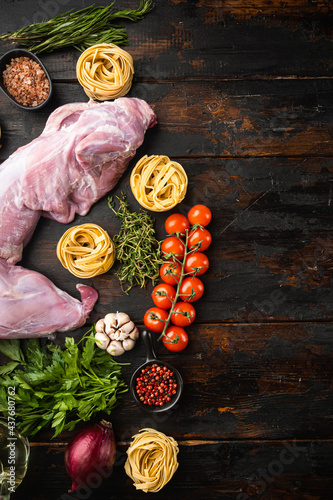 Whole rabbit, Raw meat with spices and vegetables, ingredients for stewing, on old dark wooden table background, top view flat lay, with copy space for text