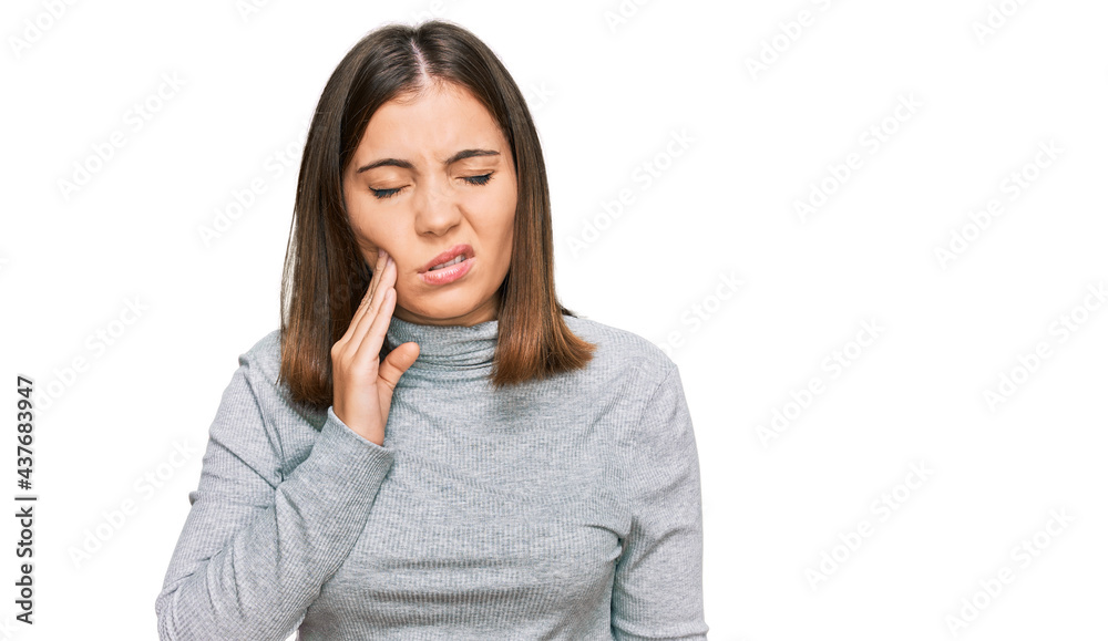 Young beautiful woman wearing casual turtleneck sweater touching mouth with hand with painful expression because of toothache or dental illness on teeth. dentist Young beautiful woman wearing casual turtleneck sweater touching mouth with hand with painful expression because of toothache or dental illness on teeth. dentist