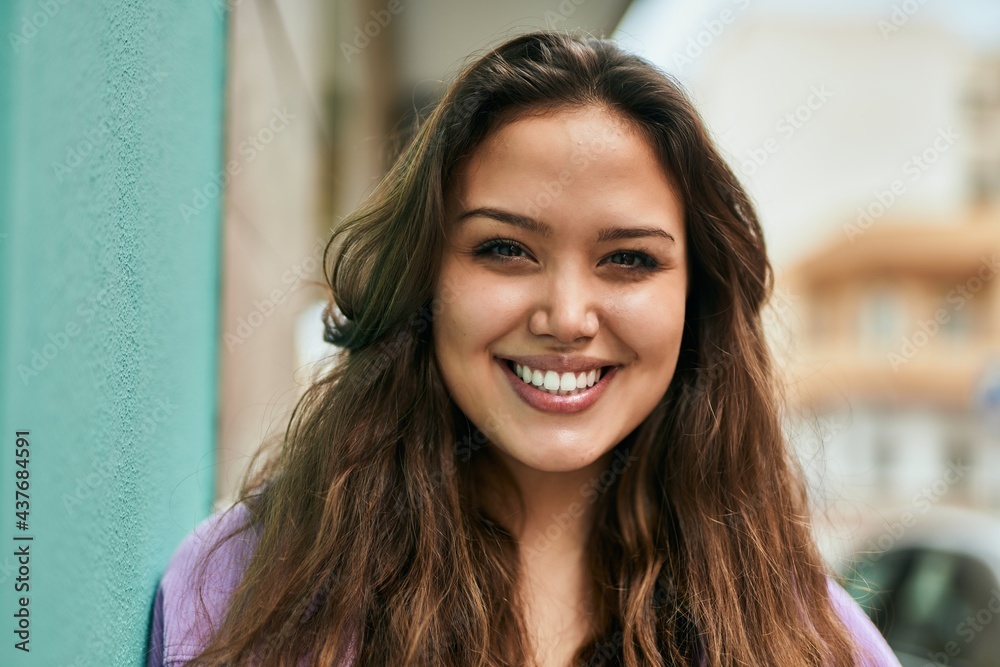 Young hispanic woman smiling happy standing at the city. Young hispanic woman smiling happy standing at the city.