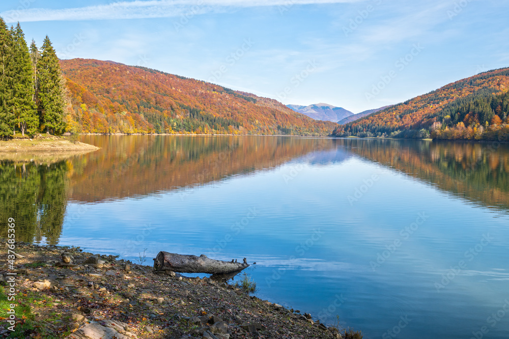 Vilshany water reservoir on the Tereblya river, Transcarpathia, Ukraine. Picturesque lake with clouds reflection. Beautiful autumn day in Carpathian Mountains.