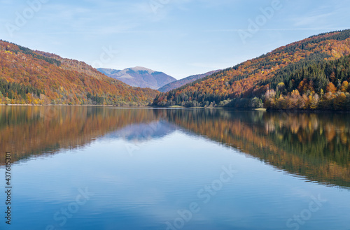 Vilshany water reservoir on the Tereblya river, Transcarpathia, Ukraine. Picturesque lake with clouds reflection. Beautiful autumn day in Carpathian Mountains.