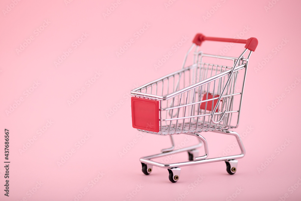 Shopping cart on pink background Shopping cart on pink background