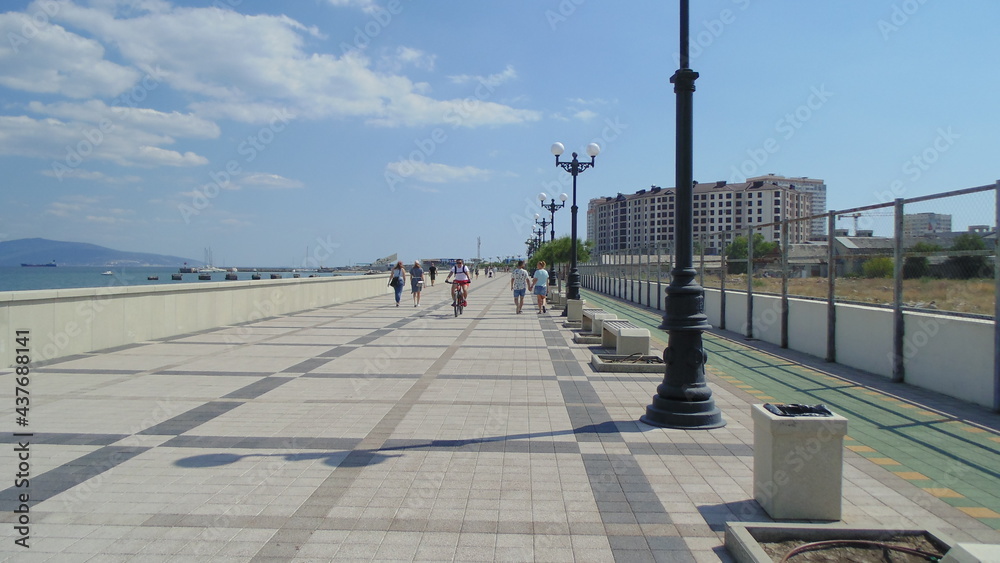 The walking area of ​​the seaside town embankment on a sunny, clear day.