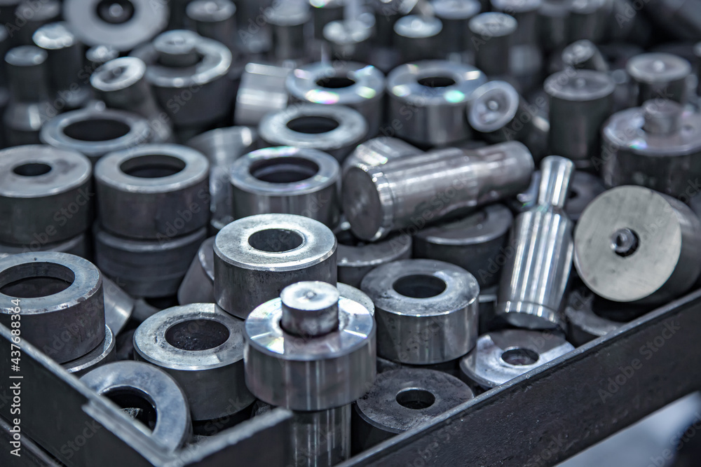 A batch of shiny metal parts production - close-up with selective focus for industrial background A batch of shiny metal parts production - close-up with selective focus for industrial background