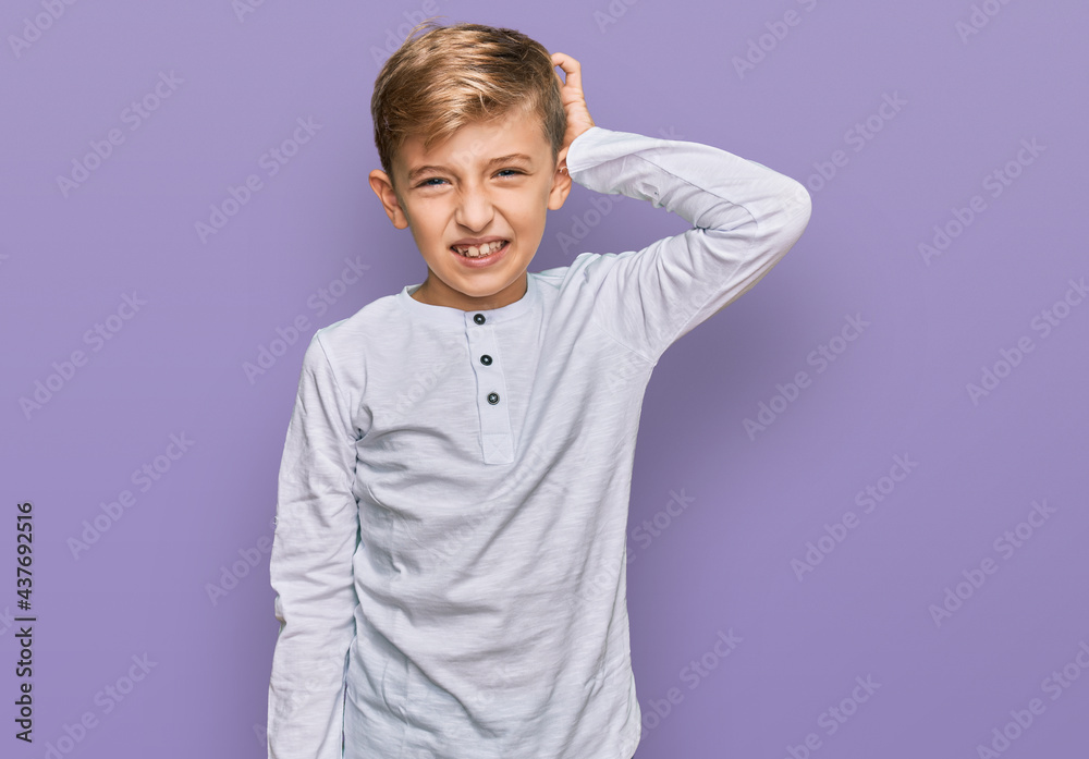 Little caucasian boy kid wearing casual clothes confuse and wonder about question. uncertain with doubt, thinking with hand on head. pensive concept. Little caucasian boy kid wearing casual clothes confuse and wonder about question. uncertain with doubt, thinking with hand on head. pensive concept.