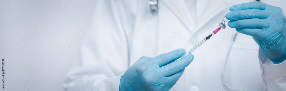 Doctor or scientist with a stethoscope holding COVID-19 vaccine, measles, coronavirus vaccine shot for diseases outbreak vaccination, vaccine Concept fight against virus covid-19 corona virus Doctor or scientist with a stethoscope holding COVID-19 vaccine, measles, coronavirus vaccine shot for diseases outbreak vaccination, vaccine Concept fight against virus covid-19 corona virus