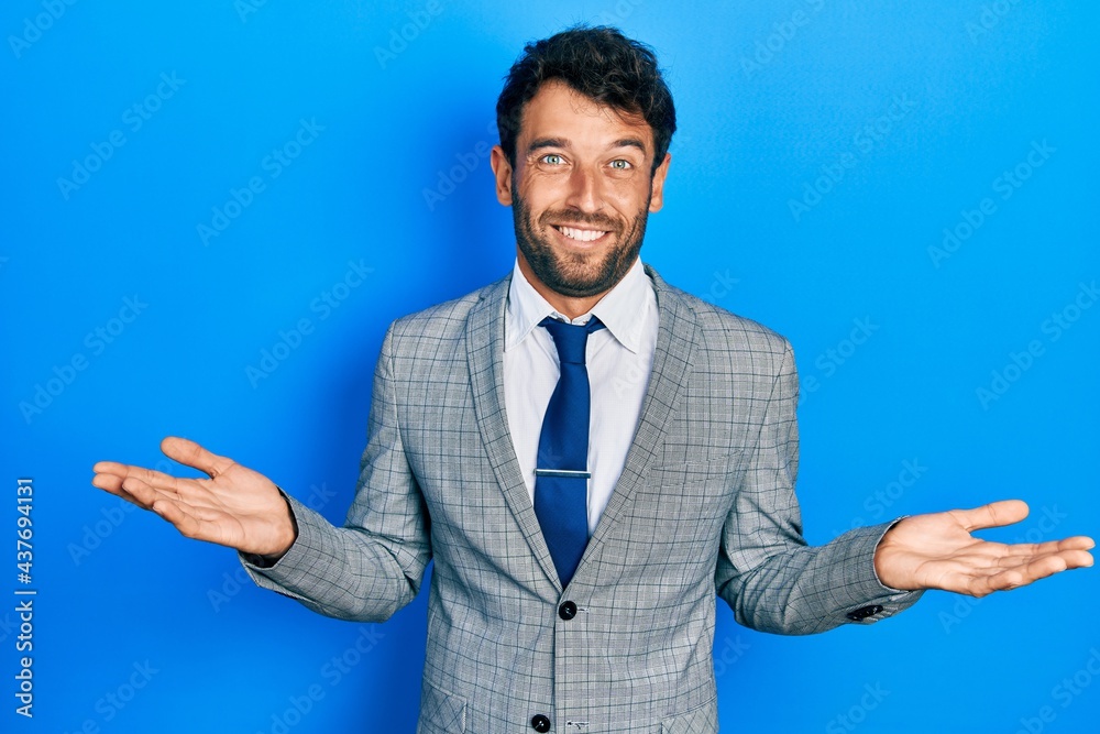 Handsome man with beard wearing business suit and tie clueless and confused expression with arms and hands raised. doubt concept. Handsome man with beard wearing business suit and tie clueless and confused expression with arms and hands raised. doubt concept.