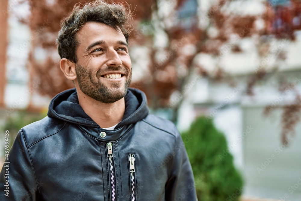 Handsome hispanic man with beard smiling happy outdoors Handsome hispanic man with beard smiling happy outdoors