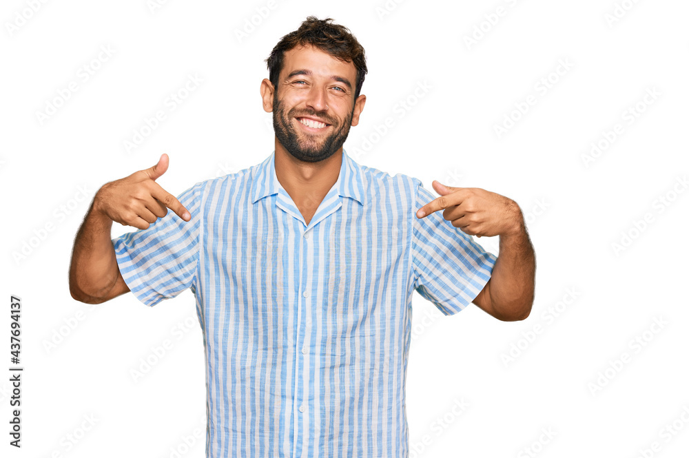 Handsome young man with beard wearing casual fresh shirt looking confident with smile on face, pointing oneself with fingers proud and happy. Handsome young man with beard wearing casual fresh shirt looking confident with smile on face, pointing oneself with fingers proud and happy.