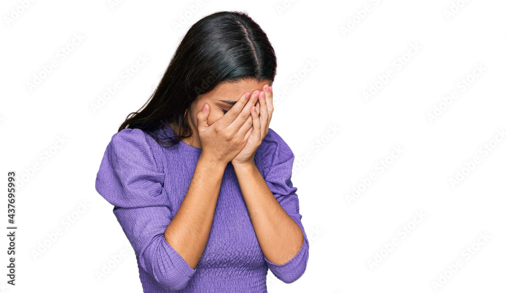 Young hispanic girl wearing casual clothes with sad expression covering face with hands while crying. depression concept. Young hispanic girl wearing casual clothes with sad expression covering face with hands while crying. depression concept.