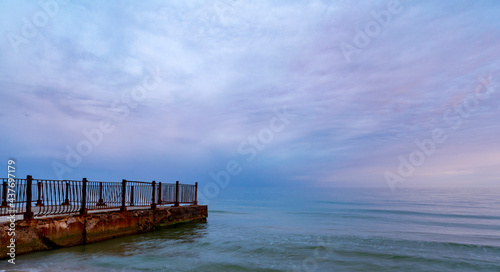 Beautiful sunrise on the old sea pier