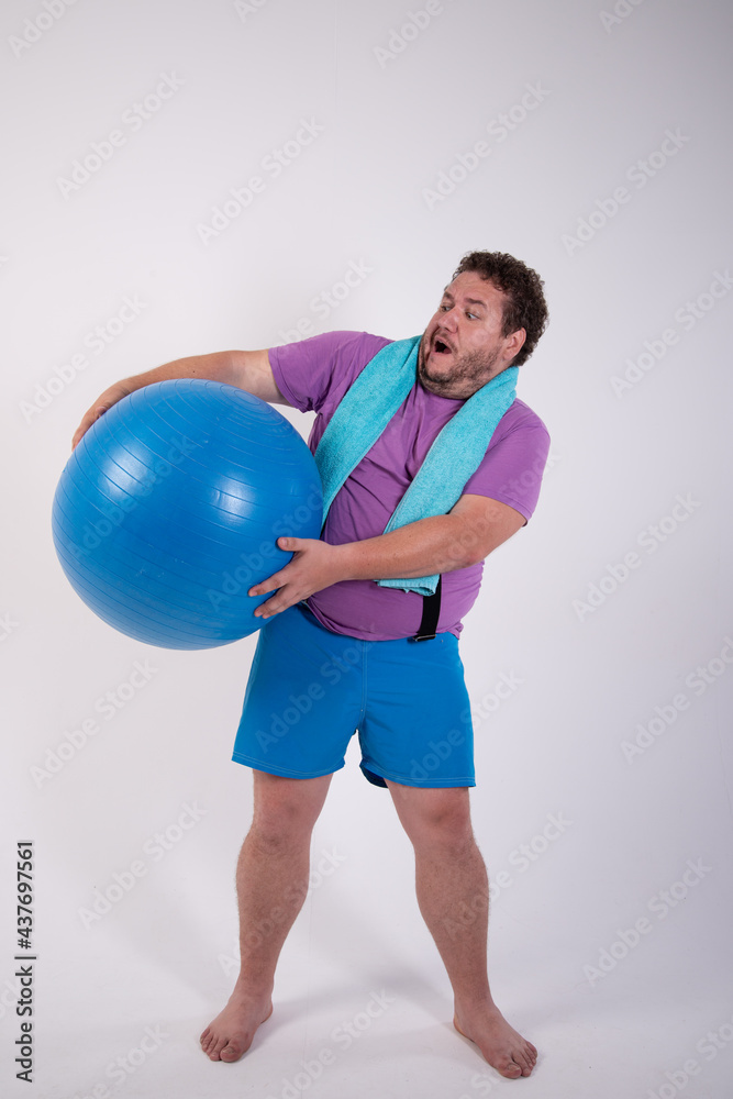 Funny fat man is engaged in fitness.