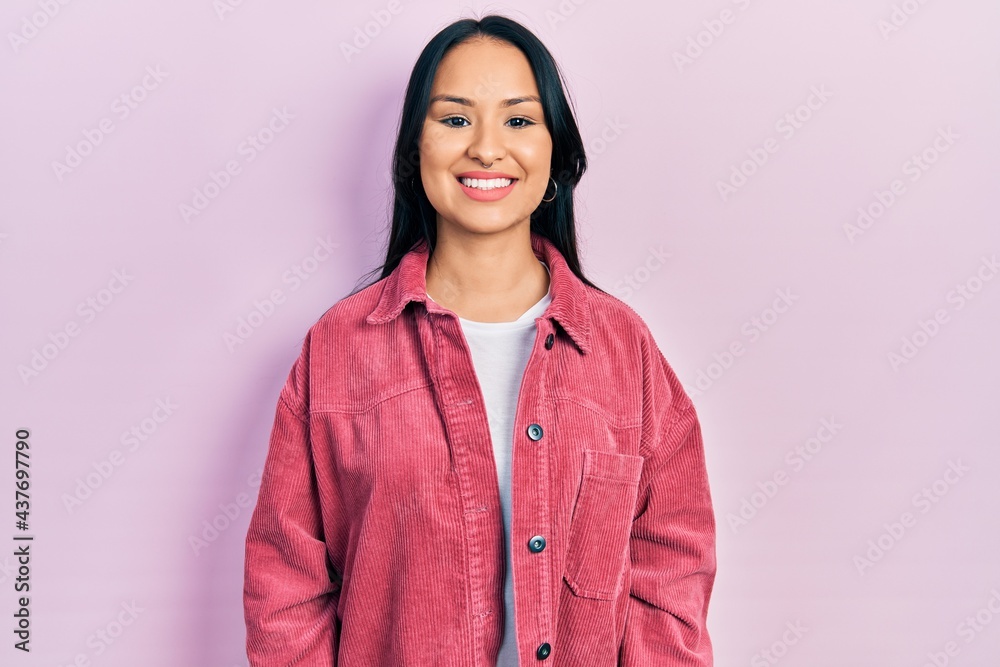 Beautiful hispanic woman with nose piercing wearing casual pink jacket with a happy and cool smile on face. lucky person. Beautiful hispanic woman with nose piercing wearing casual pink jacket with a happy and cool smile on face. lucky person.