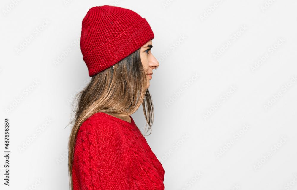 Young hispanic woman wearing casual clothes looking to side, relax profile pose with natural face with confident smile. Young hispanic woman wearing casual clothes looking to side, relax profile pose with natural face with confident smile.