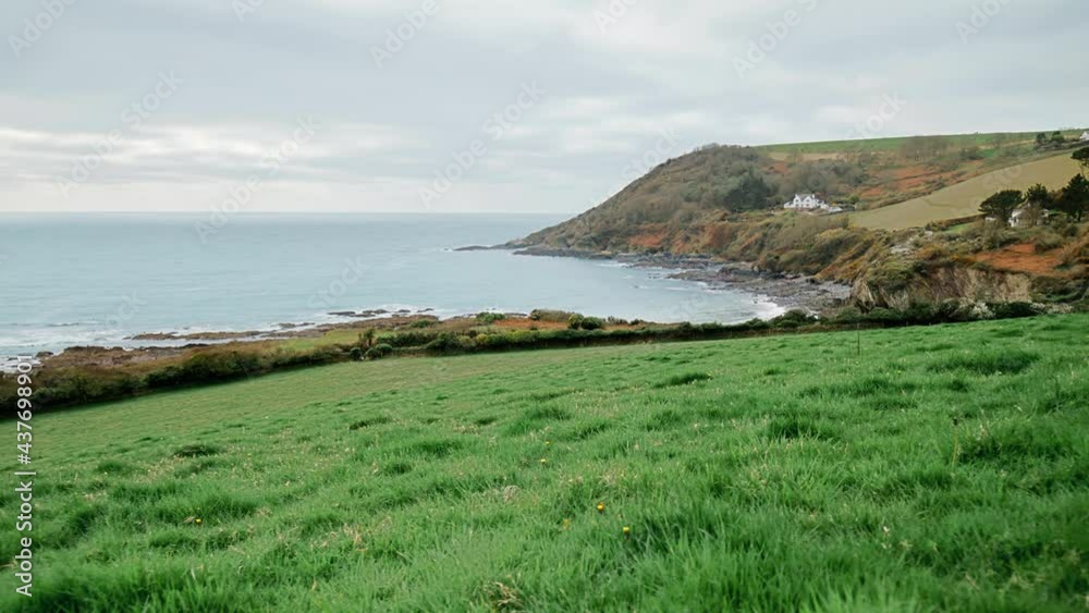 Talland Bay Beach - a quiet place midway between Looe and Polperro in 4K. Talland Bay, Porthallow - beautiful scenic rocky location in Cornwall, England with Holiday Houses on the seashore edge. Talland Bay Beach - a quiet place midway between Looe and Polperro in 4K. Talland Bay, Porthallow - beautiful scenic rocky location in Cornwall, England with Holiday Houses on the seashore edge.