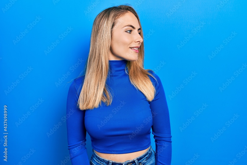 Young caucasian woman wearing casual clothes looking to side, relax profile pose with natural face and confident smile. Young caucasian woman wearing casual clothes looking to side, relax profile pose with natural face and confident smile.