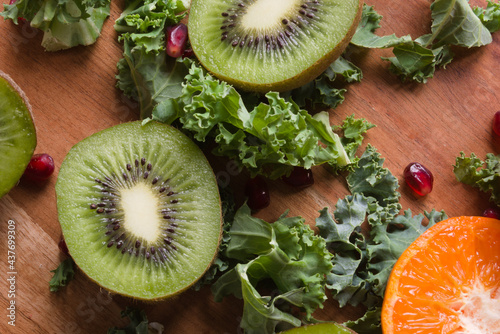 healthy food fruit grains lettuce leaves on wooden background flat lay