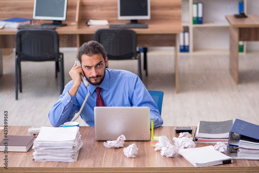 Young male employee in brainstorming concept