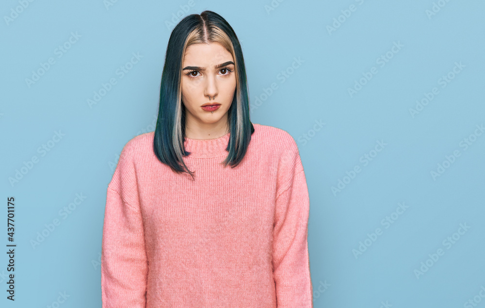 Young modern girl wearing pink wool winter sweater skeptic and nervous, frowning upset because of problem. negative person. Young modern girl wearing pink wool winter sweater skeptic and nervous, frowning upset because of problem. negative person.