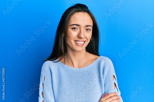 Young hispanic girl wearing casual clothes happy face smiling with crossed arms looking at the camera. positive person.