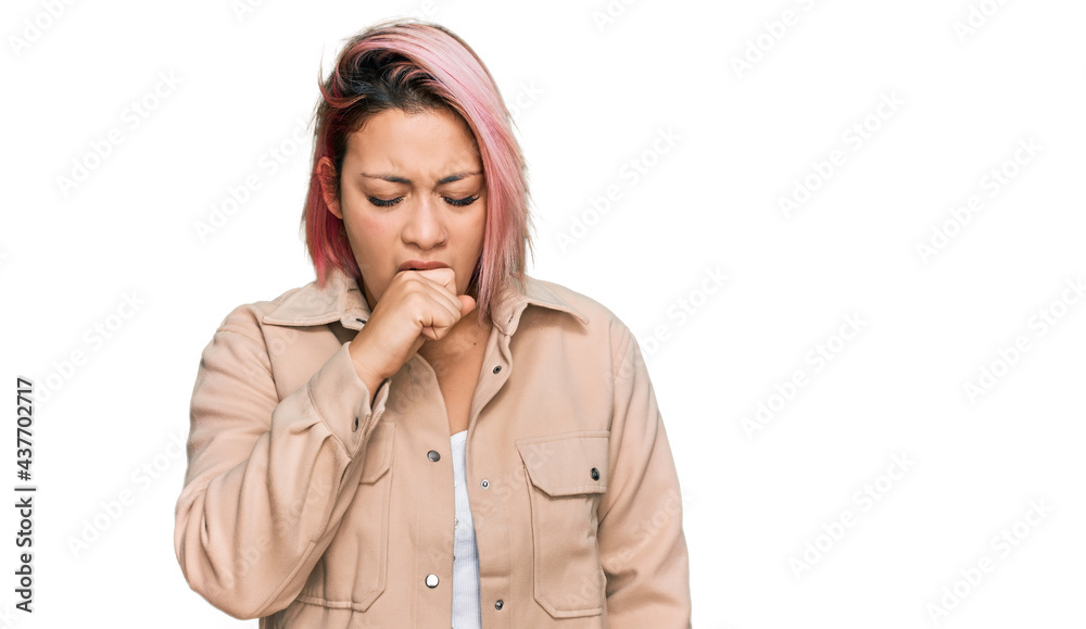 Hispanic woman with pink hair wearing casual clothes feeling unwell and coughing as symptom for cold or bronchitis. health care concept. Hispanic woman with pink hair wearing casual clothes feeling unwell and coughing as symptom for cold or bronchitis. health care concept.