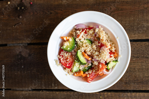 couscous salad tomato, cucumber, spices vegetable appetizer fresh portion organic on the table healthy meal snack copy space food background rustic top view 