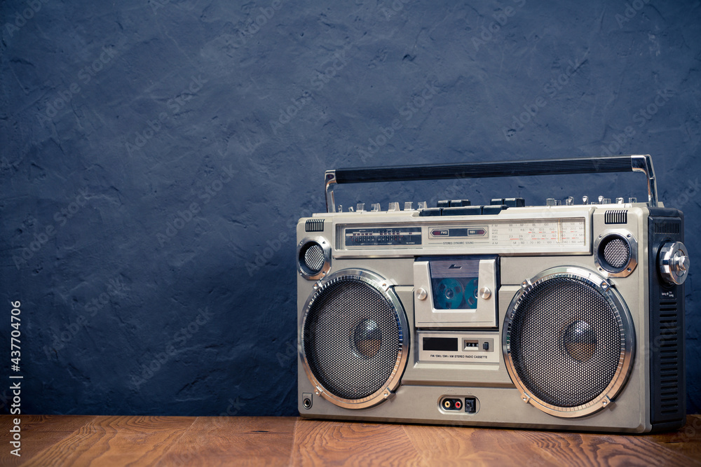 Foto Stock Retro boombox ghetto blaster outdated portable radio receiver  with cassette recorder from 80s front concrete black wall background. Rap,  Hip Hop, R&B music concept. Vintage old style filtered photo