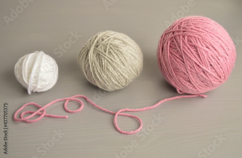pastel woolen balls on grey wooden ground