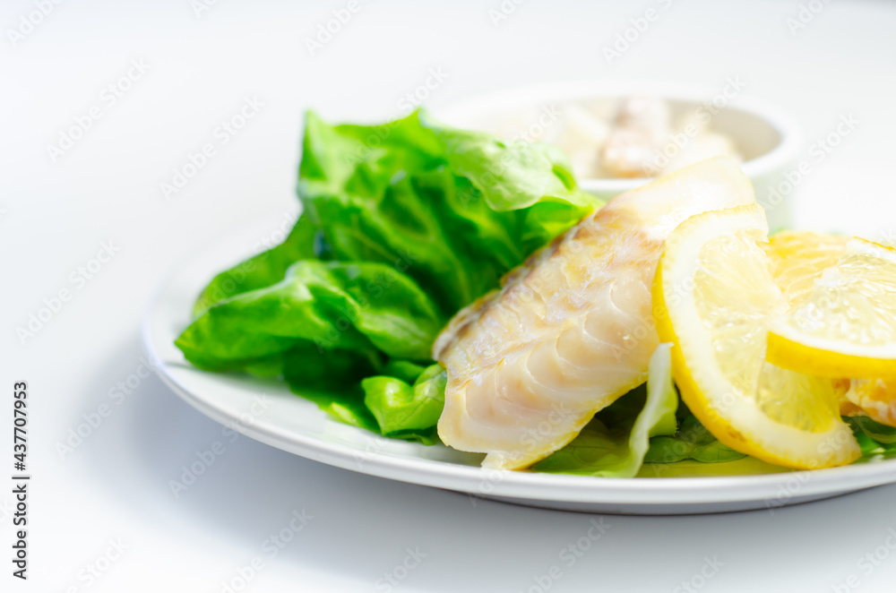 Steamed haddock fillet served with an exquisite salad consisting of cabbage, celery and apple with sultanas and roasted peanuts in mayonnaise Steamed haddock fillet served with an exquisite salad consisting of cabbage, celery and apple with sultanas and roasted peanuts in mayonnaise