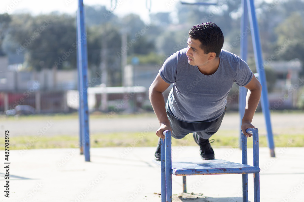 Mexican man training on a playground, poor town Mexican man training on a playground, poor town