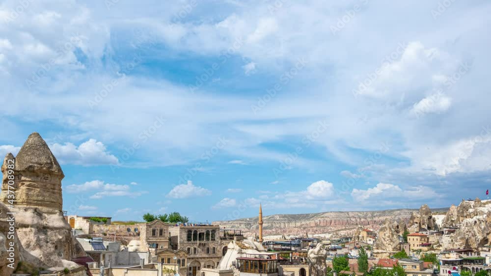 4k stock video timelapse of great amazing sunny summer landscape of Turkey country, Goreme town. View from high hill at ancient cave houses, buildings, skyline, blue sky with white fluffy clouds