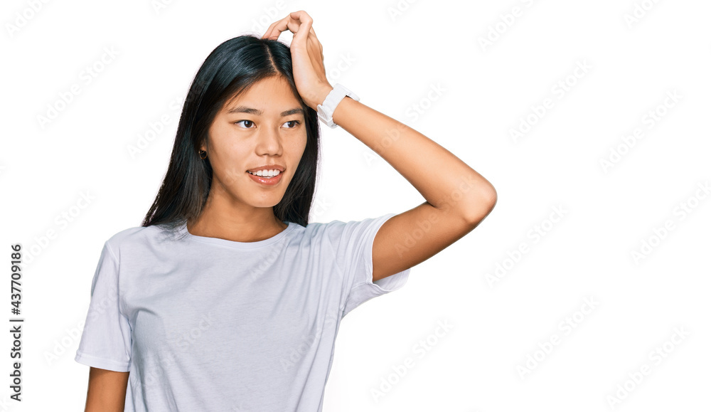 Beautiful young asian woman wearing casual white t shirt smiling confident touching hair with hand up gesture, posing attractive and fashionable Beautiful young asian woman wearing casual white t shirt smiling confident touching hair with hand up gesture, posing attractive and fashionable