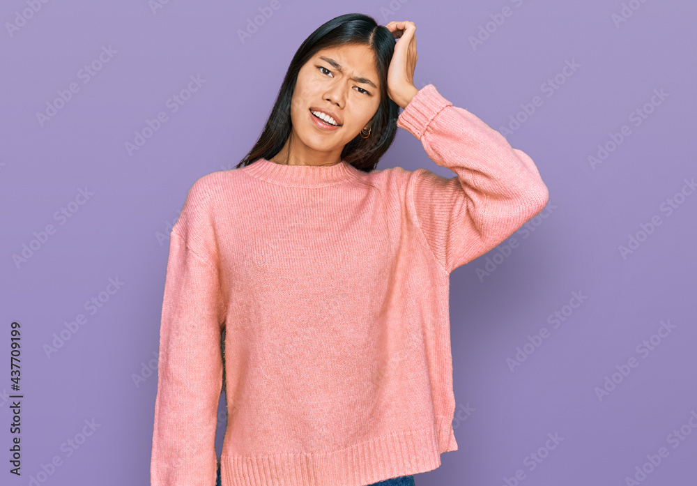 Beautiful young asian woman wearing casual winter sweater confuse and wonder about question. uncertain with doubt, thinking with hand on head. pensive concept. Beautiful young asian woman wearing casual winter sweater confuse and wonder about question. uncertain with doubt, thinking with hand on head. pensive concept.