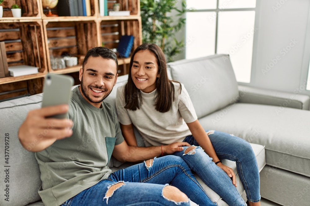 Young latin couple smiling happy making selfie by the smartphone at home. Young latin couple smiling happy making selfie by the smartphone at home.