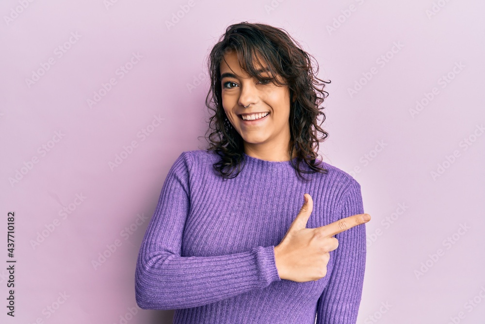 Fototapeta premium Young hispanic woman wearing casual clothes smiling cheerful pointing with hand and finger up to the side