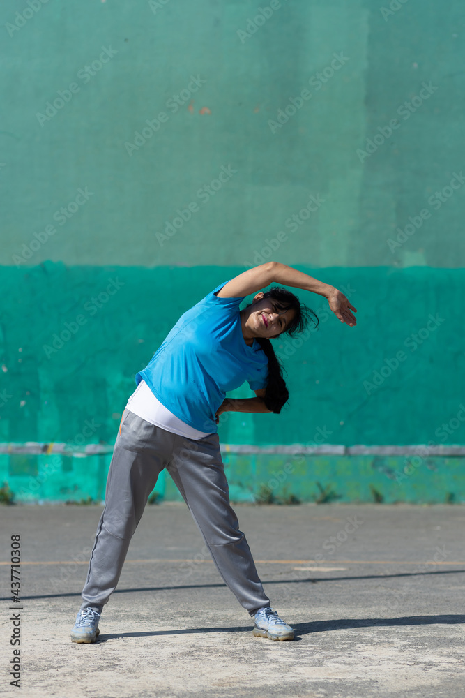 Mexican woman stretching outdoors urban exercise Mexican woman stretching outdoors urban exercise