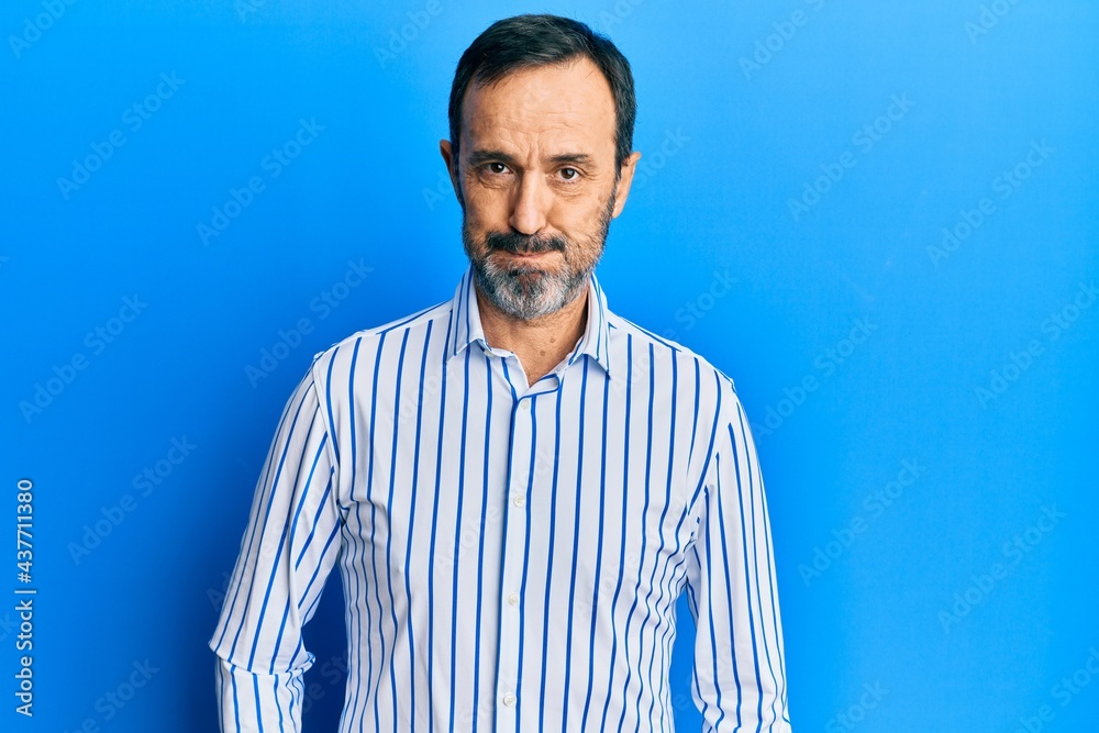 Fototapeta premium Middle age hispanic man wearing casual clothes puffing cheeks with funny face. mouth inflated with air, crazy expression.